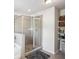 Tiled shower showcases clean lines, while open shelving adds practical storage to this bathroom at 2127 Apple Orchard Way, Austell, GA 30168