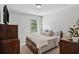 Inviting bedroom featuring a comfortable bed, dark wood furniture, and a bright window view at 2127 Apple Orchard Way, Austell, GA 30168