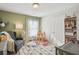 Bedroom with soft green walls, comfortable chair, and well-organized closet and sleeping area at 2127 Apple Orchard Way, Austell, GA 30168