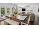 Bright dining area with a large wooden table, stylish seating, and seamless flow to the adjacent living room at 2127 Apple Orchard Way, Austell, GA 30168