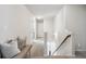 Bright upstairs hallway with a cozy bench seating area and neutral carpet at 2127 Apple Orchard Way, Austell, GA 30168