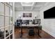 Dedicated home office with modern desk setup, hardwood floors, and ample light, ideal for remote work at 2127 Apple Orchard Way, Austell, GA 30168