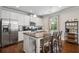 Modern kitchen with stainless steel appliances, granite countertops, and a functional center island with barstool seating at 2127 Apple Orchard Way, Austell, GA 30168