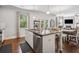 Spacious kitchen featuring a center island with seating, stainless steel appliances, and ample cabinet space at 2127 Apple Orchard Way, Austell, GA 30168
