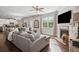 Inviting living room with a cozy fireplace, large sectional sofa, and open concept design for easy living at 2127 Apple Orchard Way, Austell, GA 30168