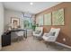 Home office setup with desk, chairs, and natural light, creating a productive workspace at 2363 Haran Dr # 35, Lithonia, GA 30058