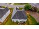 Overhead view of a home featuring a dark roof, green lawn, and proximity to a street corner at 4676 Shaded Oak Ln, Forest Park, GA 30297