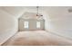 Large, carpeted bedroom with vaulted ceiling, ceiling fan, and natural light from two windows at 4676 Shaded Oak Ln, Forest Park, GA 30297