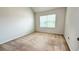 Bright and neutral bedroom with a window at 4676 Shaded Oak Ln, Forest Park, GA 30297