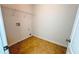 Small laundry room with tile floor, utility sink hookups, and storage shelf at 4676 Shaded Oak Ln, Forest Park, GA 30297