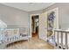 Cozy Bedroom offers two cribs, wood laminate flooring and closet storage at 118 Greenwood St, Fairburn, GA 30213