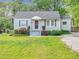 Charming one-story home featuring a well-manicured lawn and inviting front porch at 118 Greenwood St, Fairburn, GA 30213