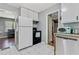 Kitchen featuring white appliances, and white cabinets with views into the living room at 118 Greenwood St, Fairburn, GA 30213