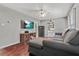View of living room featuring hardwood floors, a sectional sofa, and a mounted television at 118 Greenwood St, Fairburn, GA 30213