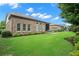 Beautiful backyard showcasing a well-maintained lawn, landscaping, and a covered patio with seating at 2115 Creekstone Point Dr, Cumming, GA 30041