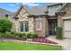Charming home exterior with a stone and brick facade, landscaped flower beds, and a welcoming entryway at 2115 Creekstone Point Dr, Cumming, GA 30041