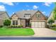 Charming single-Gathering home boasts a manicured lawn, stone accents, and a two-car garage at 2115 Creekstone Point Dr, Cumming, GA 30041