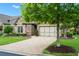Charming single-Gathering home features manicured lawn, stone and brick facade, and lush landscaping at 2115 Creekstone Point Dr, Cumming, GA 30041