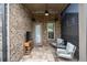 Covered brick patio area with comfortable seating, a ceiling fan, and an outdoor view at 2115 Creekstone Point Dr, Cumming, GA 30041