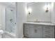 Bathroom with gray vanity, marble countertop, and glass enclosed shower at 3564 Liberty Ln, Marietta, GA 30062