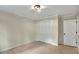 This is a bedroom with neutral walls, beige carpeting, and a closet with folding louvered doors at 3564 Liberty Ln, Marietta, GA 30062