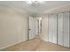 This bedroom offers neutral walls, beige carpeting, and a closet with folding louvered doors at 3564 Liberty Ln, Marietta, GA 30062