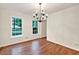 Light-filled dining room featuring hardwood floors and modern chandelier at 3564 Liberty Ln, Marietta, GA 30062
