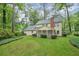 A spacious backyard with a screened-in porch, mature trees, and a well-kept lawn at 3564 Liberty Ln, Marietta, GA 30062