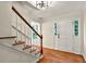 Inviting foyer with hardwood floors, staircase, and a bright white front door at 3564 Liberty Ln, Marietta, GA 30062