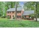 Charming two-story brick home with black shutters, lush landscaping, and a well-maintained front yard at 3564 Liberty Ln, Marietta, GA 30062