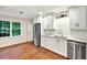 Modern kitchen with white cabinets, stainless steel appliances, and hardwood floors at 3564 Liberty Ln, Marietta, GA 30062