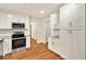 This kitchen features ample storage, stainless appliances, and bright white cabinets at 3564 Liberty Ln, Marietta, GA 30062