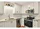 Bright kitchen features stainless steel appliances, white cabinets, tile backsplash, and marble countertops at 3564 Liberty Ln, Marietta, GA 30062