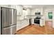 Updated kitchen boasts stainless steel appliances, white cabinetry and gorgeous hardwood floors at 3564 Liberty Ln, Marietta, GA 30062