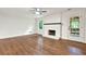Living room with hardwood floors, white brick fireplace, and access to the outdoors at 3564 Liberty Ln, Marietta, GA 30062