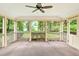 The screened-in porch has a ceiling fan and a wooded backyard view, offering a peaceful outdoor living space at 3564 Liberty Ln, Marietta, GA 30062