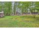 Large, grassy backyard bordered by mature trees and a chain link fence at 421 Fond Du Lac Dr, Stone Mountain, GA 30088