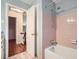 A well-lit bathroom features a tiled shower and a staircase view through an open door at 421 Fond Du Lac Dr, Stone Mountain, GA 30088
