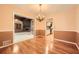 Formal dining room featuring chandelier and hardwood floors and view to living room and kitchen at 421 Fond Du Lac Dr, Stone Mountain, GA 30088