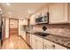 Modern kitchen with stainless steel appliances, granite countertops, and tile backsplash at 421 Fond Du Lac Dr, Stone Mountain, GA 30088