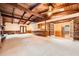 Spacious living room with exposed beam ceiling, brick fireplace, and access to dining area at 421 Fond Du Lac Dr, Stone Mountain, GA 30088