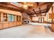 Large living room featuring a brick fireplace, exposed beams, skylights, and custom built-ins at 421 Fond Du Lac Dr, Stone Mountain, GA 30088
