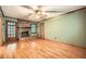 A cozy living room features hardwood floors, a ceiling fan, and a brick fireplace at 421 Fond Du Lac Dr, Stone Mountain, GA 30088