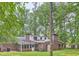 Rear exterior of brick home with screened in porch and mature trees at 421 Fond Du Lac Dr, Stone Mountain, GA 30088