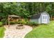 Backyard featuring a charming gazebo, a fire pit, and shed, perfect for outdoor enjoyment at 5761 E Emerald Oaks Ln, Acworth, GA 30102