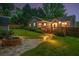 Inviting backyard featuring a stone fire pit, wooden deck, and manicured lawn at 5761 E Emerald Oaks Ln, Acworth, GA 30102