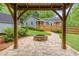 Inviting backyard featuring a stone patio, fire pit, wooden deck, and lush greenery at 5761 E Emerald Oaks Ln, Acworth, GA 30102