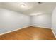 Basement space with laminate wood flooring and neutral paint at 5761 E Emerald Oaks Ln, Acworth, GA 30102