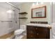 Bathroom featuring glass shower, dark wood vanity, and floating shelves at 5761 E Emerald Oaks Ln, Acworth, GA 30102