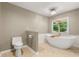 Bright bathroom with modern fixtures and free-standing tub under a window at 5761 E Emerald Oaks Ln, Acworth, GA 30102